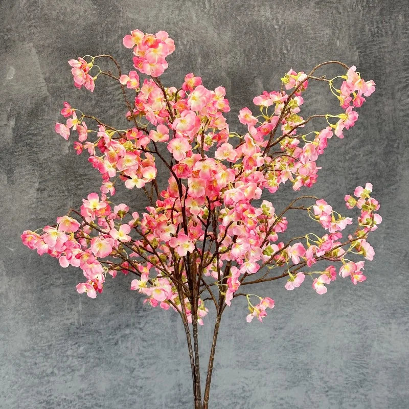 Infuse timeless serenity with these 40in Artificial Cherry Blossom Stems. Lifelike faux sakura branches bring ethereal Japanese elegance to weddings or homes.
