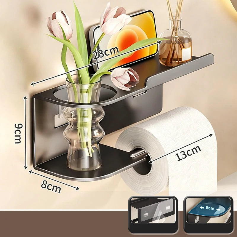 Elevate bathroom refinement with this No-Drill Toilet Paper Holder and Shelf. Wall-mounted organizer discreetly dispenses rolls while showcasing plants, toiletries, or accents.
