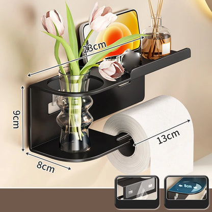 Elevate bathroom refinement with this No-Drill Toilet Paper Holder and Shelf. Wall-mounted organizer discreetly dispenses rolls while showcasing plants, toiletries, or accents.