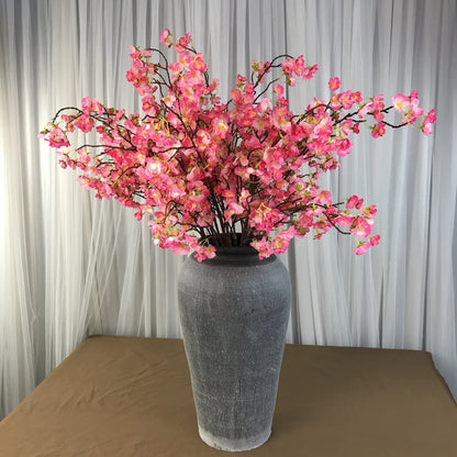 Infuse timeless serenity with these 40in Artificial Cherry Blossom Stems. Lifelike faux sakura branches bring ethereal Japanese elegance to weddings or homes.