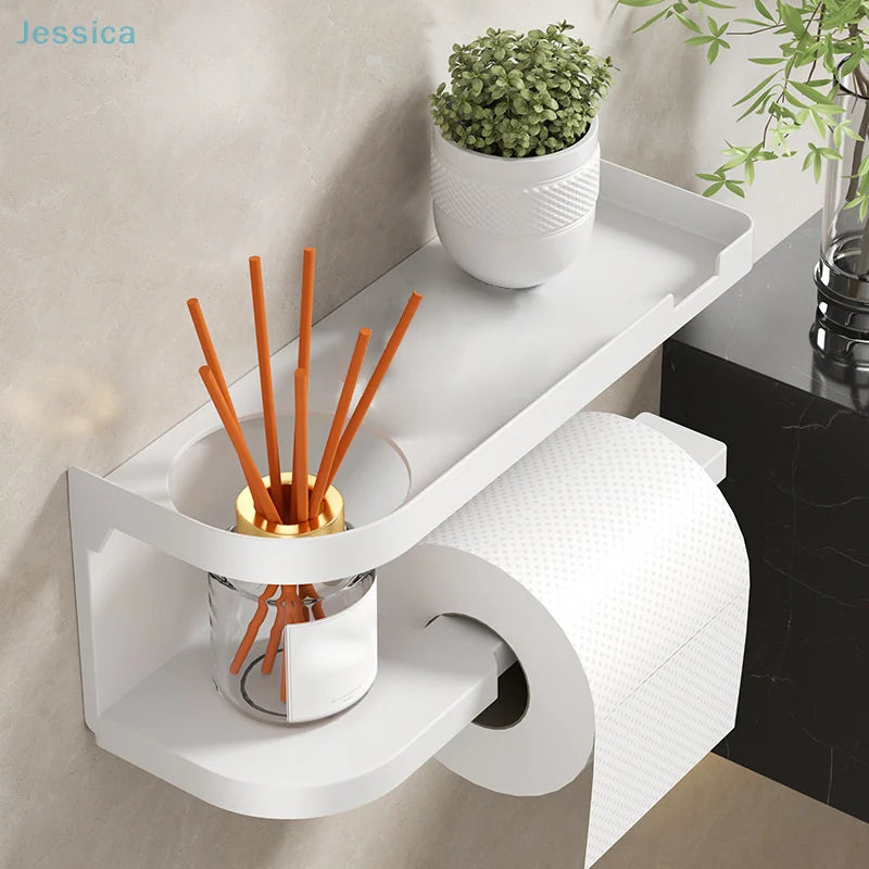 Elevate bathroom refinement with this No-Drill Toilet Paper Holder and Shelf. Wall-mounted organizer discreetly dispenses rolls while showcasing plants, toiletries, or accents.